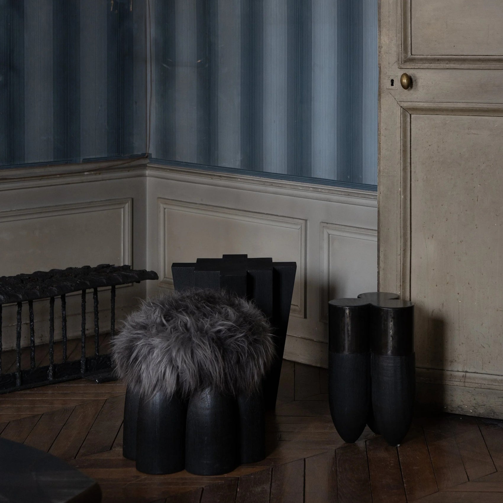 Senufo Ottoman by Arno DeClercq, featuring Black African Walnut and Sheep Wool in a stylish interior setting.