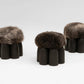 Senufo Ottoman by Arno DeClercq featuring Black African Walnut and Sheep Wool, showcasing a sculptural design.
