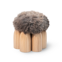 Senufo Ottoman by Arno DeClercq featuring natural sheep wool and Black African Walnut legs.