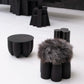 Senufo Ottoman by Arno DeClercq features Black African Walnut base and Sheep Wool for a sculptural seating experience.