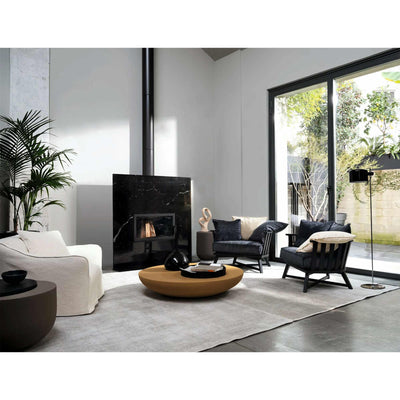 Gervasoni Saia 05 Armchair in living room with marble fireplace. Pictured with Gervasoni Heiko 43 and 44 side tables. White Chairs USA.