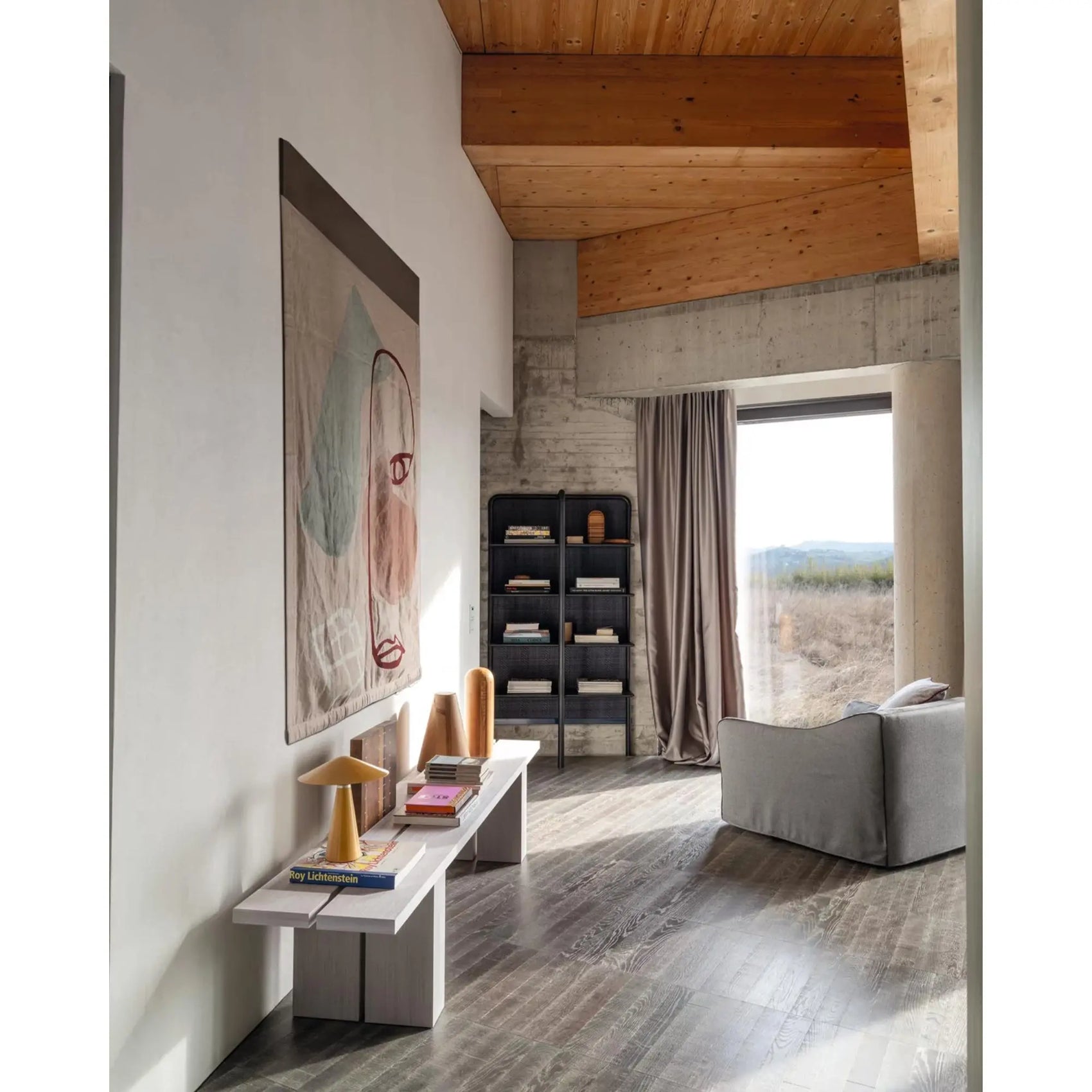 Gervasoni Saia 05 Armchair (back view) in hallway near window. Pictured with Gervasoni Daen 72 bookshelf. Chairs USA.