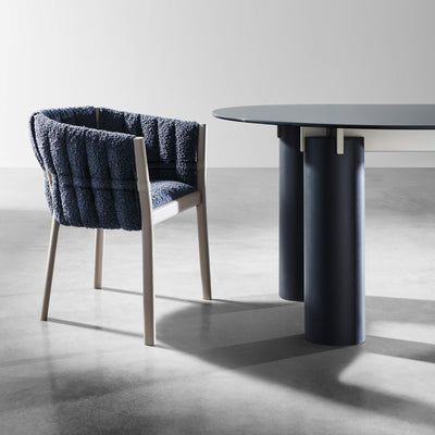 Gervasoni Daen 33 Table close-up of table legs in blueberry. Pictured with plush blue armchair. Tables USA.